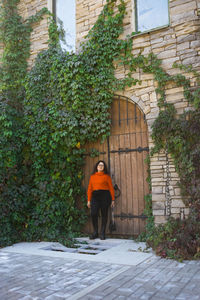 Rear view of woman walking on footpath