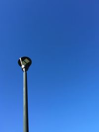 Low angle view of street light against clear blue sky