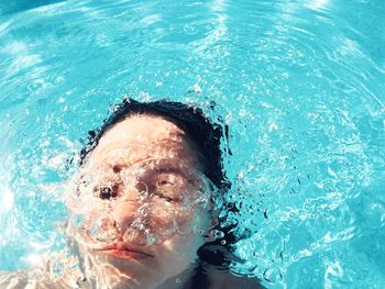 Woman swimming in swimming pool