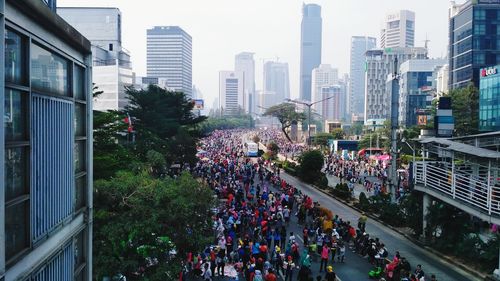 People on street amidst buildings in city