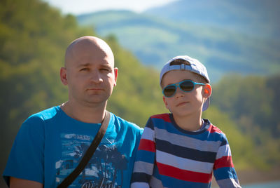 Portrait of father and son against mountain