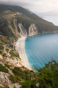 High angle view of sea and mountains against sky