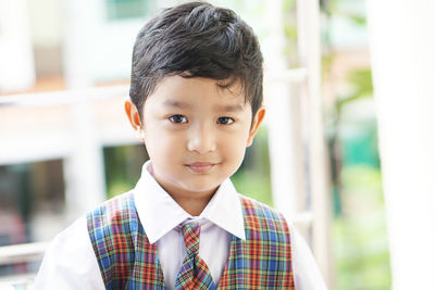 Portrait of cute boy standing outdoors