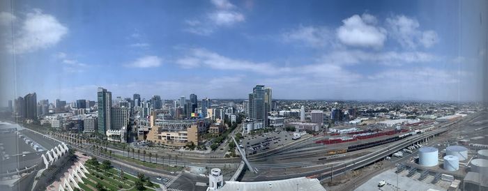 High angle view of city street and buildings against sky