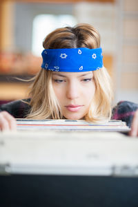 Close-up of young woman choosing vinyl records