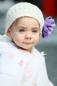 Cute baby girl standing on footpath