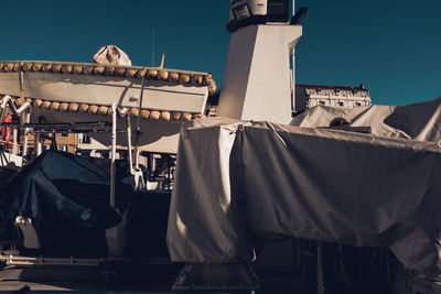 Low angle view of clothes drying on building against sky