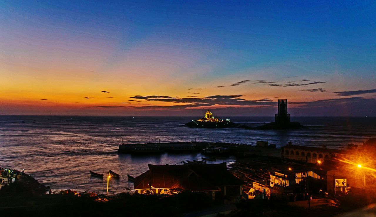 SILHOUETTE OF BUILDINGS AT WATERFRONT