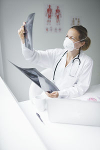 Close-up of doctor examining medical x-ray at clinic