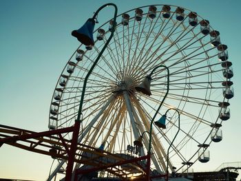 Low angle view of ferris wheel against sky