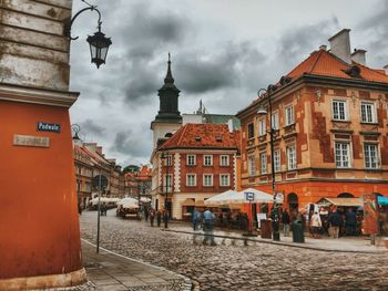 Buildings against cloudy sky