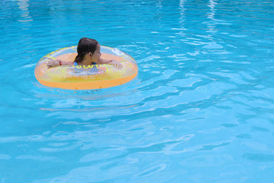 High angle view of girl swimming in pool