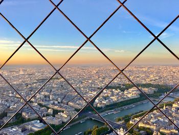 View of city seen through chainlink fence