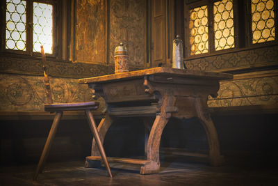 Chairs and table by window in building