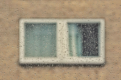 Full frame shot of wet window in rainy season