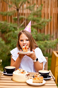 Portrait of a girl sitting on table