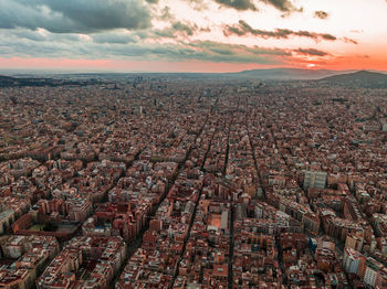 Aerial view of cityscape against sky during sunset