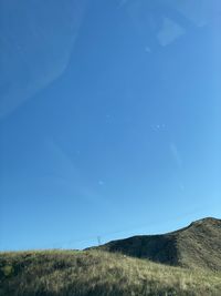 Scenic view of field against blue sky