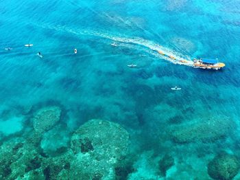 High angle view of boat sailing in blue sea