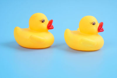 Close-up of yellow toys against blue background