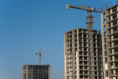 Low angle view of buildings against clear blue sky