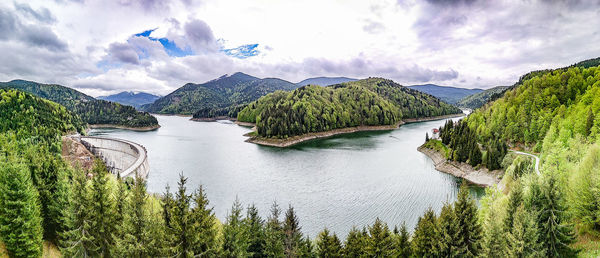 Panoramic view of river amidst trees against sky