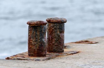 Close-up of rusty metals by sea