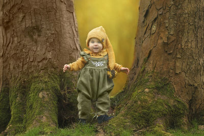 Portrait of young woman standing in forest