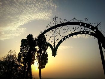Low angle view of silhouette trees against sky at sunset