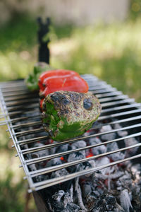 Close-up of bell peppers roasting on barbecue grill