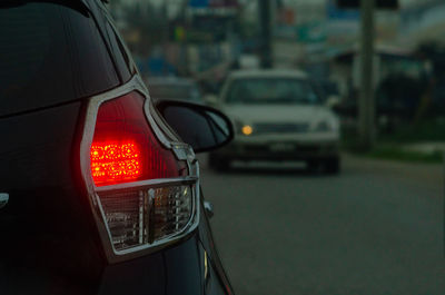 Illuminated street light on road in city