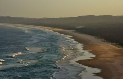 View of calm beach against clear sky