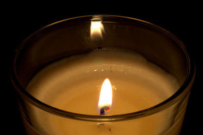 High angle view of lit candle in darkroom
