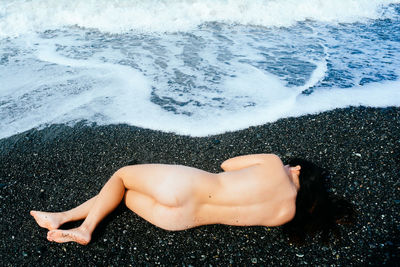 High angle view of woman relaxing on beach