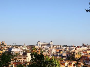 Cityscape against clear blue sky