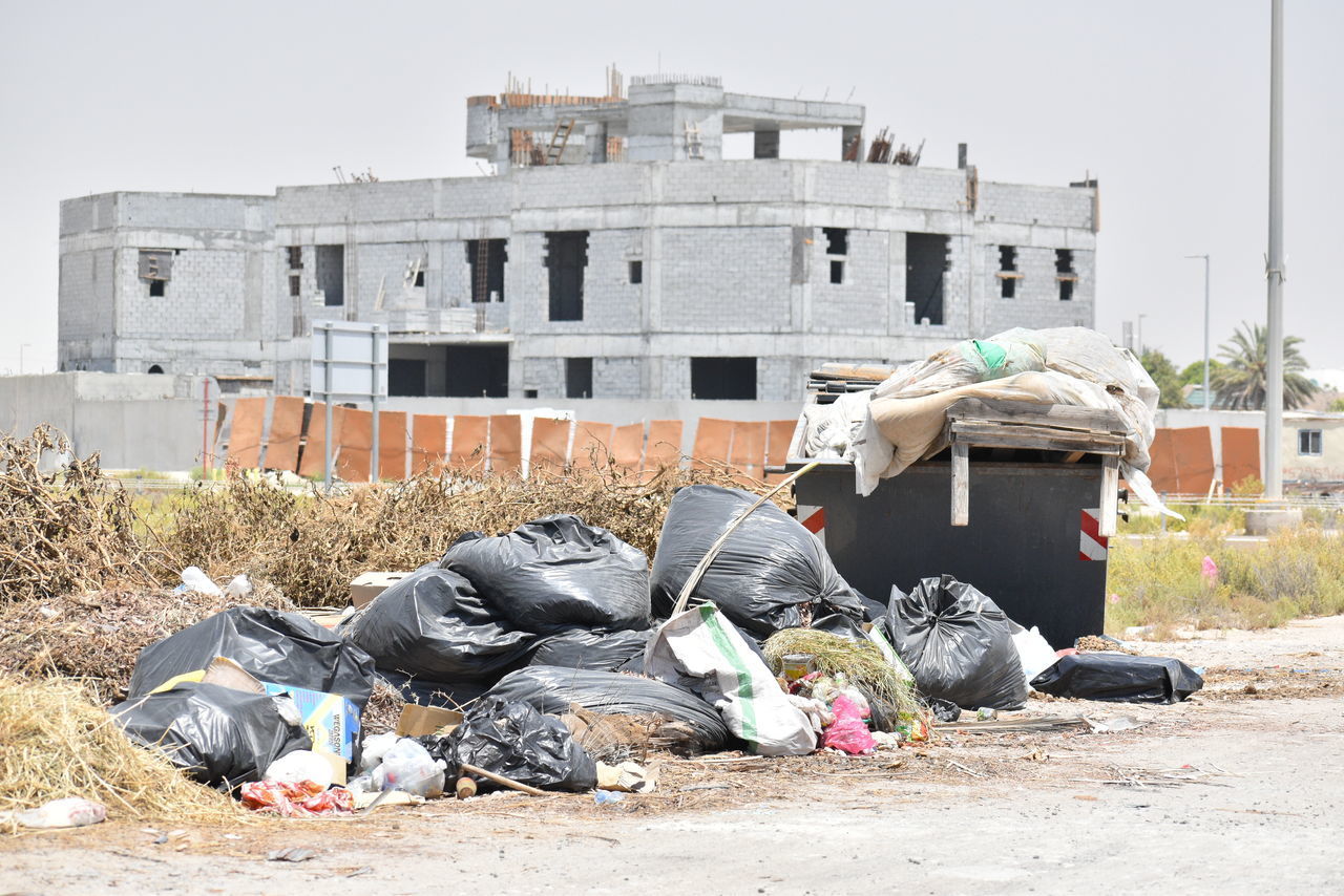 GARBAGE IN BUILDING AGAINST SKY