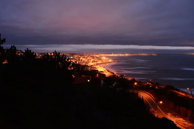 Aerial view of city lit up at sunset