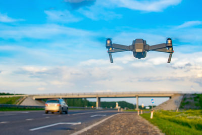 Quadcopter with a video surveillance camera hovered on the highway for monitoring, speed control