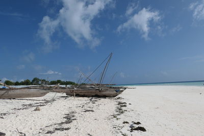 Sailboat on beach against sky