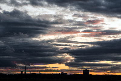 Scenic view of dramatic sky over silhouette landscape