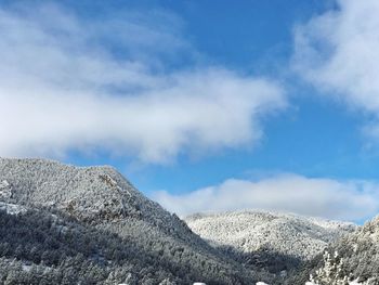 Low angle view of snowcapped mountain against sky