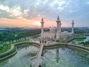 High angle view of mosque against cloudy sky during sunset