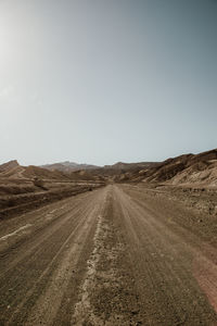 Dirt road amidst land