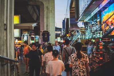 People walking on street in city at dusk