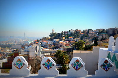 High angle view of buildings against clear blue sky