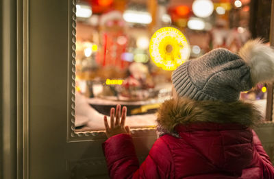 Girl looking at a christmas shop window