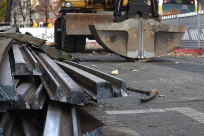 Pile of metal tracks lying on road at construction site