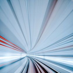 Blurred motion of illuminated tunnel in city