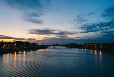 Scenic view of river against sky at sunset