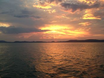 Scenic view of seascape during sunset against cloudy sky